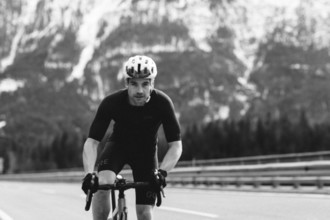 Road bike rider in spring between Lechtal and Tannheimer Tal in front of picturesque scenery of the