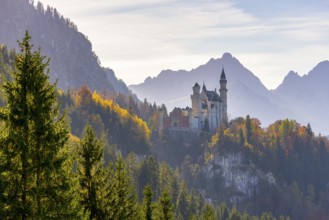 Neuschwanstein Castle surrounded by colourful autumn leaves and majestic Alps, Neuschwanstein,