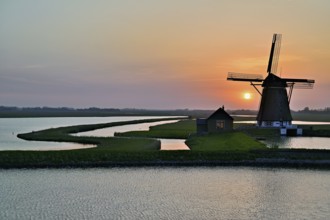 Historic windmill in the light of the setting sun, De Traanroeier, Het Noorden Molen, Texel, North