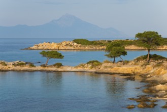 Picturesque bay with tree-covered rocks and mountain views, Karidi beach, Karydi, Mount Athos in