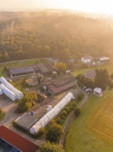 Close-up of a farm with buildings, meadows and fields at sunset, Gechingen, Black Forest, Germany,