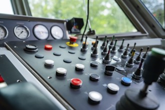 Detailed view of an industrial control panel with knobs and levers, track construction Hermann