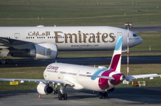 Düsseldorf Airport, Emirates Boeing 777 and Eurowings Airbus aircraft on the apron, taxiway, North