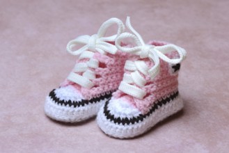 Baby shoes with pink background, handmade