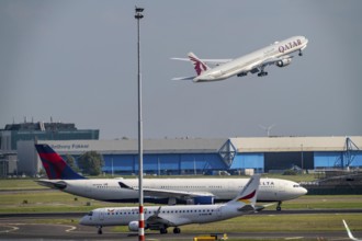 Amsterdam Schiphol Airport, aircraft on the taxiway, Qatar Airways plane takes off from the