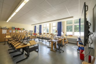 Classroom of a fourth grade, after school, the building is older but in good condition, modern