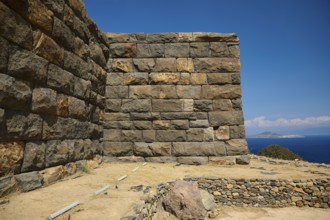 Stone walls of an ancient ruin overlooking the sea under a clear sky, Palaiokastro, Ancient