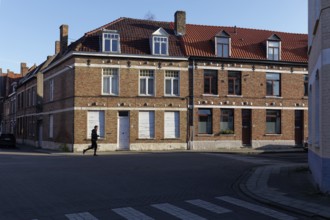 Jogger running in front of old brick houses, Bruges, West Flanders, Flanders, Belgium, Europe