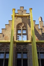 Steel girders support staircase gable of a historic house facade, gutting, construction site,