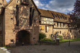 The upper gate La Porte Haute and half-timbered houses of the town wall of Riquewihr, Alsace,