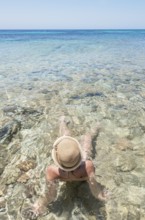 Woman relaxing in the cliear water of Formentera island, Formentera, Balearic Islands, Spain,