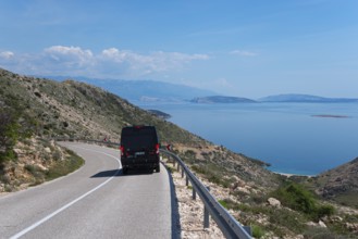 Scenic road with a motorhome and breathtaking sea view, camper, mountain road towards Stara Baška,