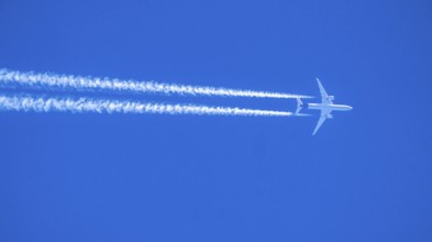 Airbus A350 aircraft in the sky, contrails, Lufthansa flight from Los Angeles to Munich, overflight