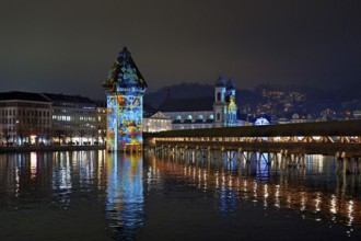 Wassertum with light installation, Chapel Bridge on the right, Jesuit Church on the Reuss at dusk