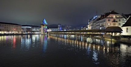 Wassertum with light installation, Chapel Bridge on the right, Jesuit Church on the Reuss at dusk