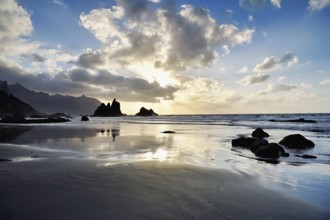 Dramatic clouds with rock formation at sunset on the beach of Playa de Benijo, Tenerife, Canary