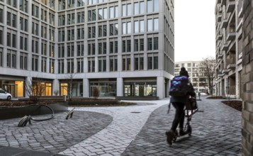 Child with a scooter in the Europacity Berlin development area on Heidestrasse. The Europacity