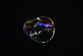 Large soap bubble in the night sky, Germany, Europe