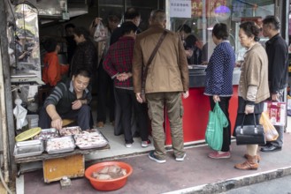 Stall selling duck giblets, including dried duck blood, an inexpensive foodstuff that is very