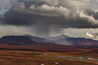 Stormy atmosphere and clouds over the autumnal Alaska Range, Denali National Park, Alaska, USA,