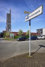 Signpost to Nordsternpark and winding tower of Nordstern colliery in Nordsternpark, Gelsenkirchen,