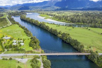 Suspension bridge over river Rio Rosselot, river Rio Palena (back), just north of village La Junta,