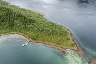 Aerial view of a bay at the Raftsund, single hut with boat, fjord between Lofoten and Vesteralen,