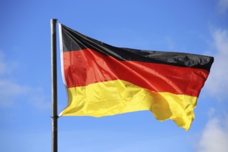 German national flag in front of a blue sky