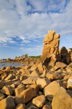 Striking orange-coloured rock formations in the evening light, on the coast of the English Channel