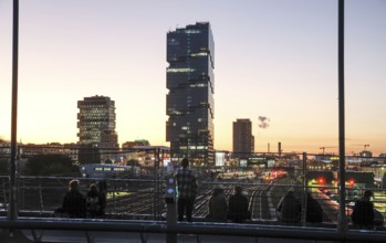 Chilling out at sunset on the Modersohn Bridge, view of railway tracks, trains and the 140 metre