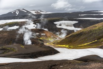 Colourful volcanic landscape with hills and snow, volcanic steaming hot springs, Laugavegur