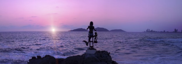 Mexico, statues near Mazatlan sea promenade, El Malecon near tourist beaches and scenic sunset