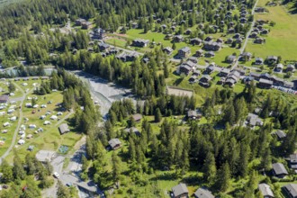 Drone shot, Camp site and village of La Fouly at a glacial river, holiday cottages, Switzerland,