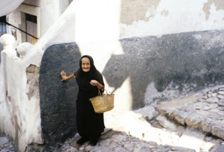 Old widow in black clothes in Ibiza Town, Ibiza, Balearic Islands, Spain 1967