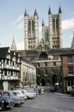 People and cars on Castle Hill square near Lincoln Cathedral, Lincolnshire, England, 1963