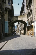 Soldiers walking along historic cobbled street in Old Town, Parte Vieja, San Sebastian,