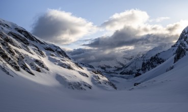 Snow-covered mountain landscape in the morning light, view into the Iffigtal, cloudy mood, high