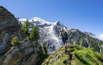 Mountaineer on a hiking trail in front of mountain landscape with glacier, view of glacier Glacier