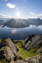 View of Fjord Raftsund and mountains in the evening light, sun star, view from the top of