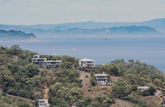 View of houses on top of a hill overlooking the beach, San Juan del Sur. Houses on top of a hill