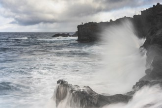 Angler on the beach and rocks, surf on Lanzarote, Spain, Europe