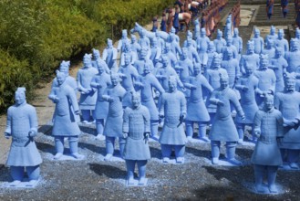 Many blue terracotta warrior statues stand on a path and appear to be in formation, Bacalhôa,