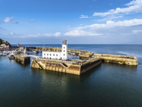 Scarborough Lighthouse and Harbour from a drone, Vincent Pier, Scarborough, North Yorkshire,