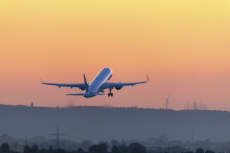 Passenger aircraft after take-off, in front of sunrise, Baden-Württemberg, Germany, Europe