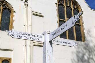 Direction pointing signpost outside Dulwich College chapel, Dulwich, London, England, UK