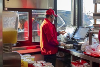 Sterling Heights, Michigan, Workers serve up Chickenjoy fried chicken at Jollibee, a Filipino fast