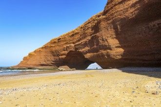 Natural rock coastal arch erosional landform on beach, Legzira, southern Morocco, north Africa