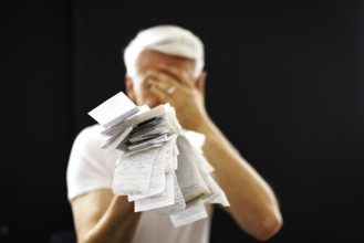 The subject of taxes. A man holds receipts in his hand in Berlin, 09/08/2024