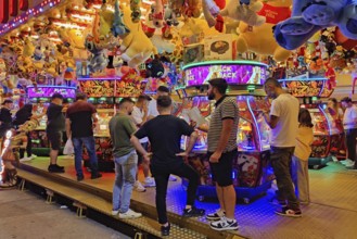 People in an illuminated pusher arcade in the evening, Cranger Kirmes, Herne, Ruhr area, North