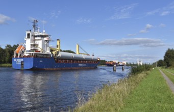 Cargo ship and container ship meet in the Kiel Canal, Kiel Canal in a ship siding,